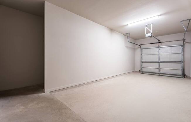 A room with a white wall and a metal shelf.