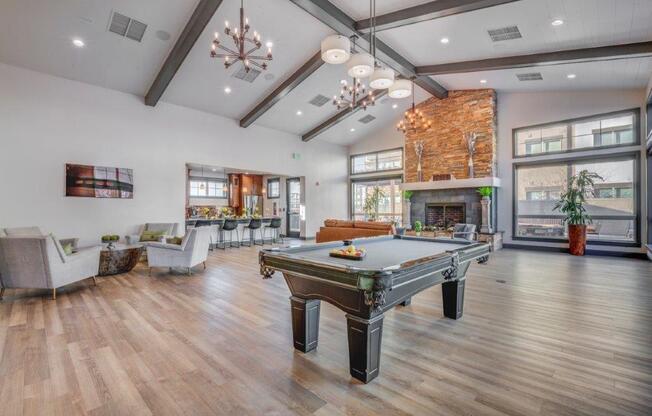 Large clubhouse with vaulted ceilings, pool table, sitting area, and fireplace