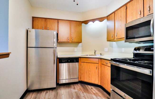 A kitchen with wooden cabinets and stainless steel appliances.