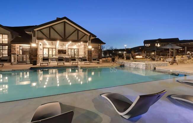 Outdoor Pool with Chaise Loungers at Dusk
