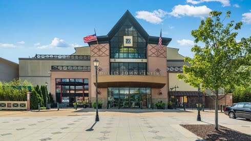 a large building with two flags in front of it