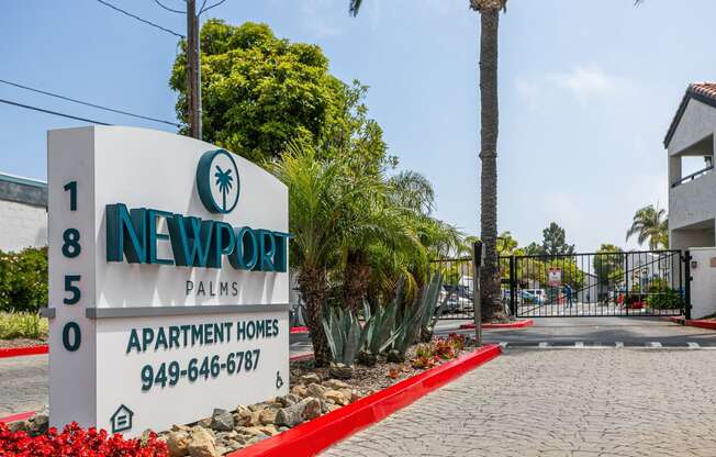 a sign homes in front of a road and palm trees