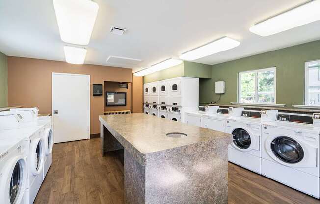 A laundry room with a washer and dryer on both sides of a central island.
