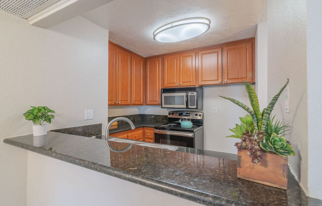 a kitchen with a granite counter top and at City View Apartments at Warner Center, California