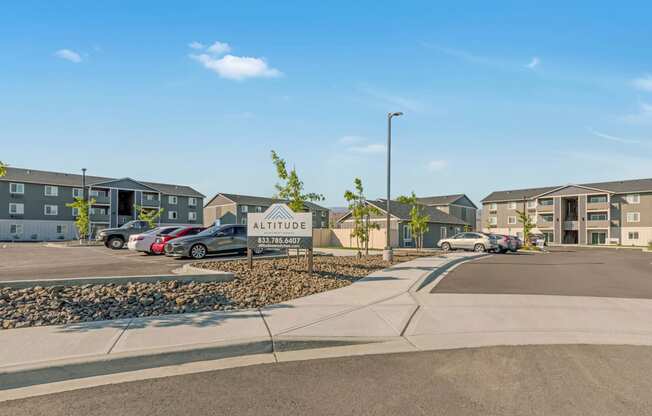 Exterior view of community buildings and parking lot. Bright blue sky and well-maintained landscaping. at Altitude, East Wenatchee