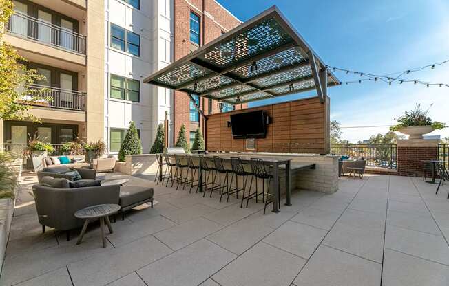A patio with a table and chairs under a canopy.