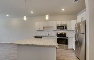 a kitchen with stainless steel appliances and a granite counter top at The Augustan, Georgia, 30901