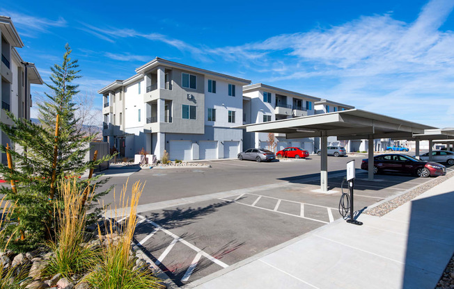 an empty parking lot in front of an apartment building