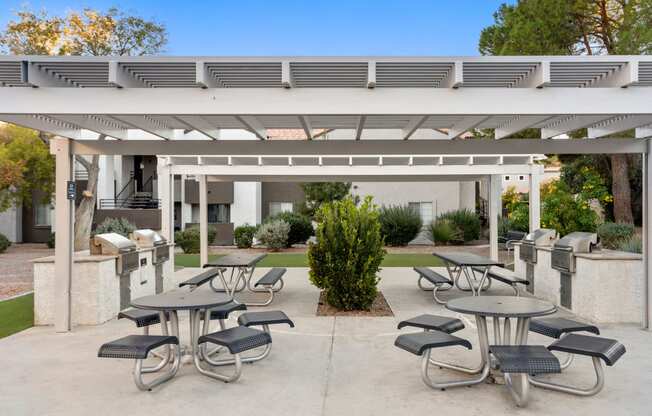 an outdoor patio with tables and chairs