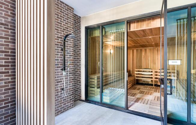 An on-site sauna with adjacent outdoor shower offers a refreshing wellness experience just steps from home.