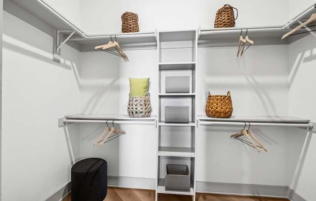 A white closet with shelves and hangers.