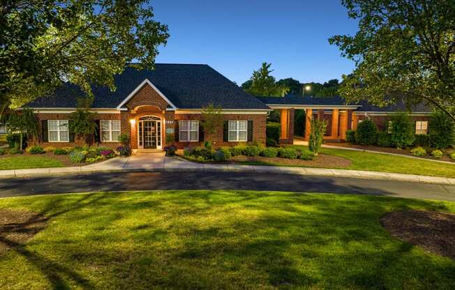 a painting of a house with a field of grass and trees