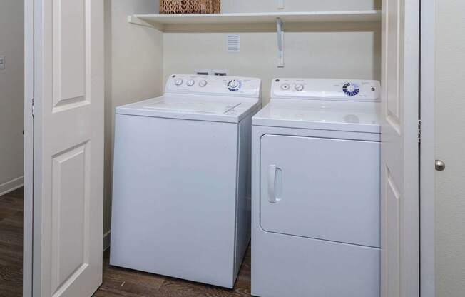 Convenient closet housing in unit washer and dryer side by side.
