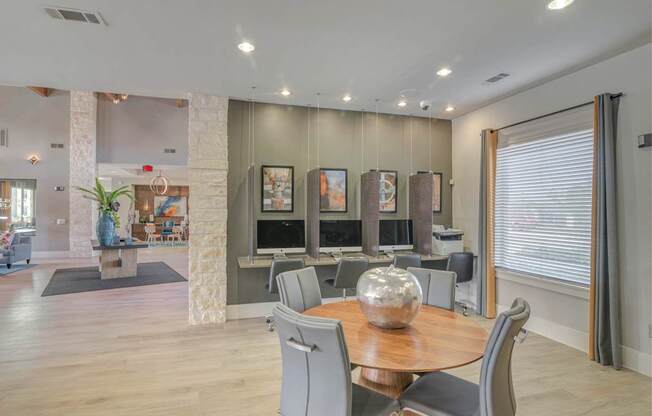 A modern dining room with a wooden table and grey chairs.
