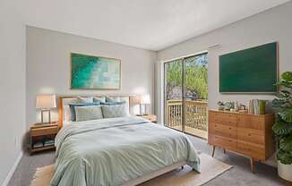 A bedroom with a large bed and a painting on the wall.