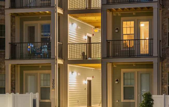 an apartment building at night with a green lawn in front of it at The Whitworth, Williamsburg, VA, 23185