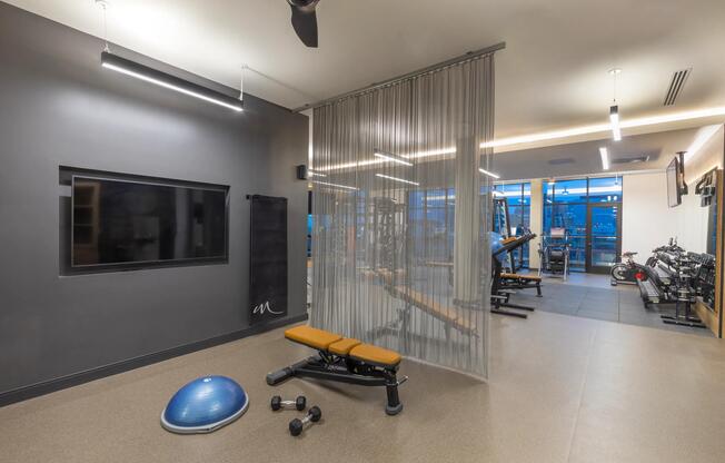 Fitness center with virtual fitness area and a variety of equipment.