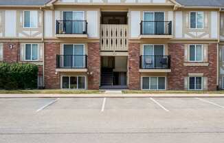 A large brick building with a white trim and a black roof.