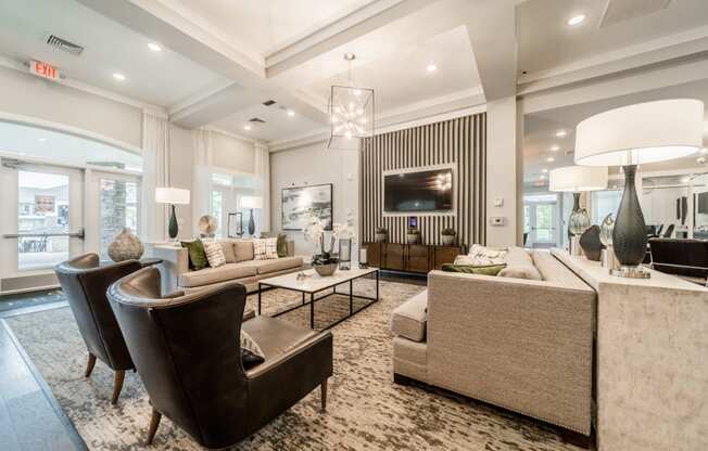 a living room with couches and chairs and a television