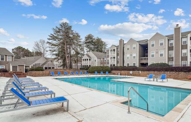 our apartments have a resort style pool with blue chairs