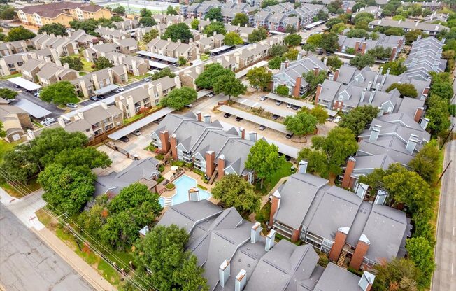 an aerial view of a neighborhood with houses and trees