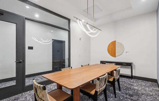 A conference room with a long table and chairs.
