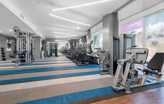 a fitness center with cardio equipment and weights in a gym