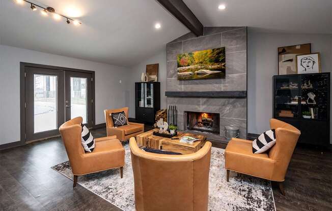 A modern living room with a fireplace and a painting above it.
