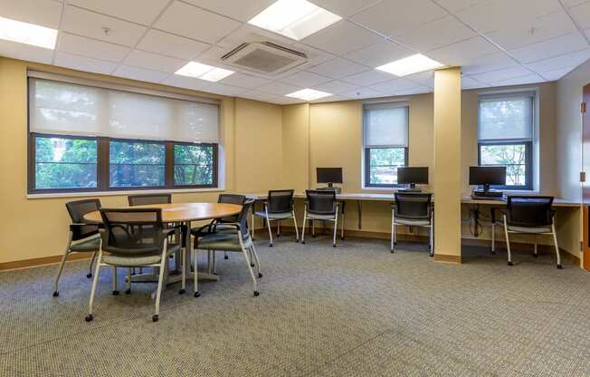A conference room with a table and chairs.