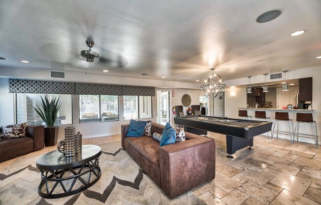 a living room with a pool table and a couch