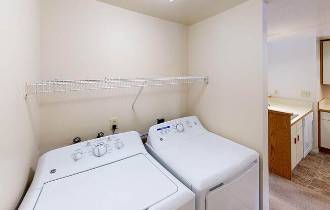 A laundry room with a washer and dryer at Foxwood and The Hermitage, Portage, MI