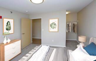 Spacious bedroom with open closet in the right corner.