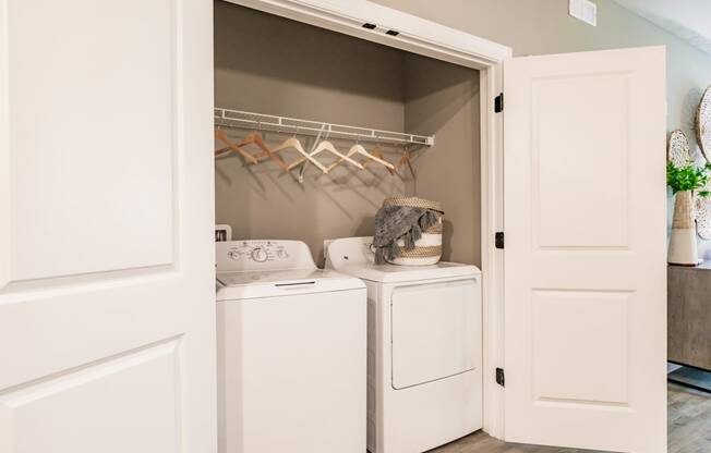 a small closet with a washer and dryer