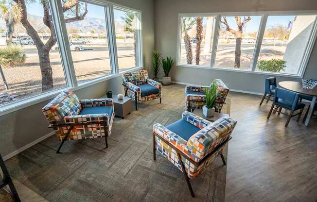 A sunny room with a couch, chair, and table.