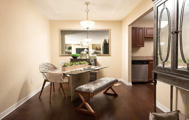 a dining room and kitchen with a table and chairs