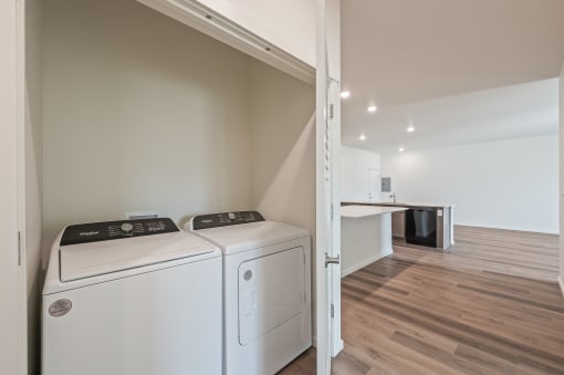 a washer and dryer in a room with a kitchen at Gateway Apartments, East Wenatchee , WA