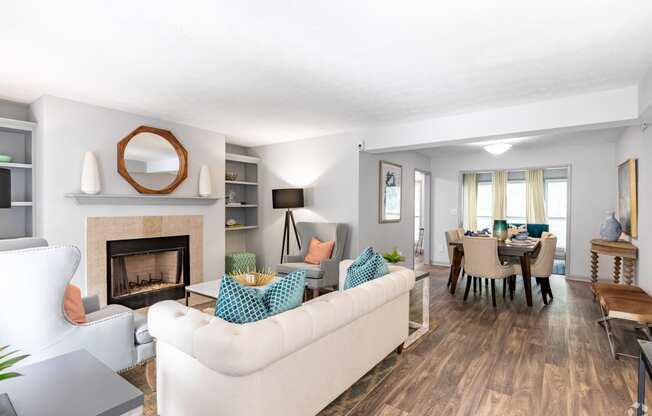 the living room and dining room of a house with a fireplace