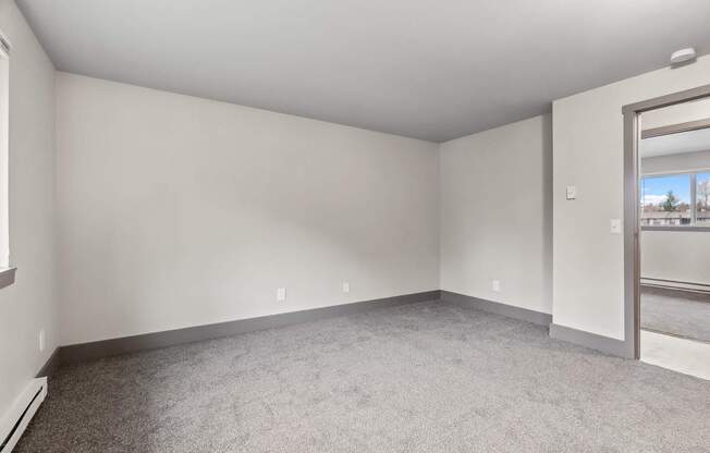 A room with a carpeted floor and a sliding glass door.