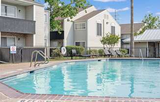 A pool surrounded by a fence with a no diving sign.