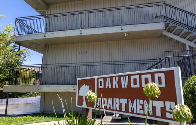 an apartment building with a sign in front of it