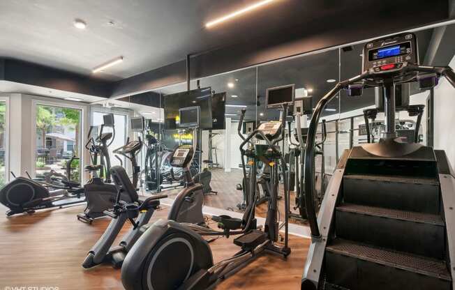 the gym is equipped with cardio equipment and weights