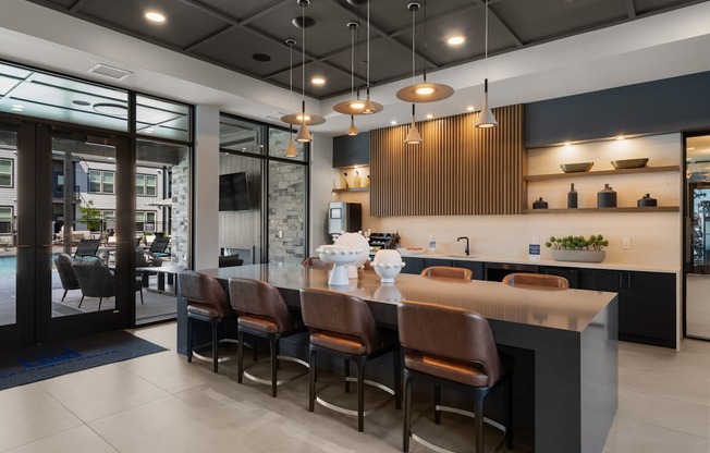 A modern kitchen with a bar area and a dining table.