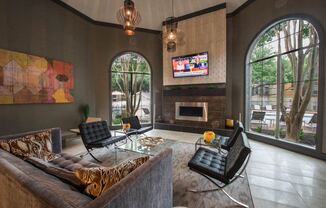 a living room with a couch and chairs and a television