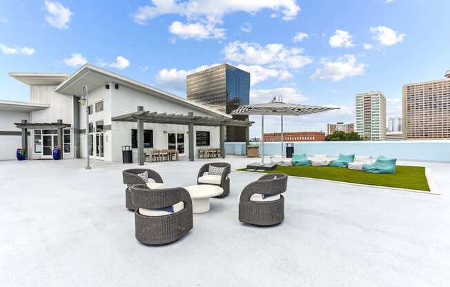 A white building with a patio area in front.