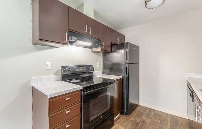 a kitchen with brown cabinets and stainless steel appliances