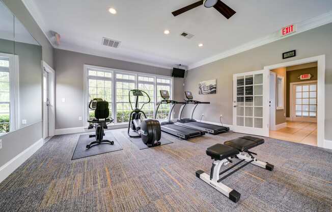 Fitness Center with Weight Bench, Treadmills, Elliptical, Recumbent Bike and Mirrored Wall