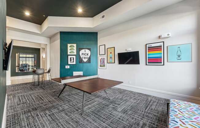 a conference room with a table and a wall with paintings