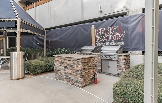 the outdoor patio of a restaurant with a grill and a sign