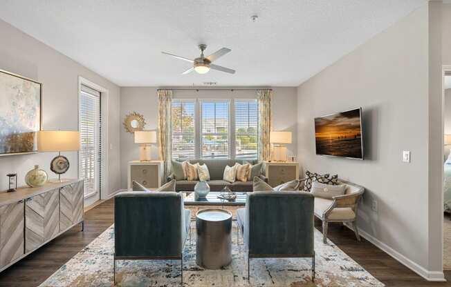 a living room with a couch and a ceiling fan