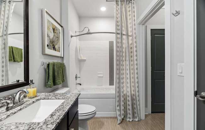 A bathroom with a white toilet and a white sink.
